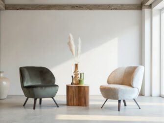 Fauteuil in mintgroene stof met afgeronde rug en zwart metalen poten