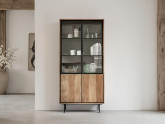 elegante hoge kast met vakindeling, waarin decoratieve objecten en boeken netjes gepresenteerd worden