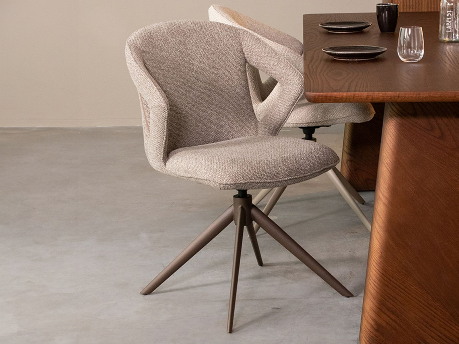 Comfortabele eetkamerstoel in zacht Mushroom Bouclé, ondersteund door een bronzen frame