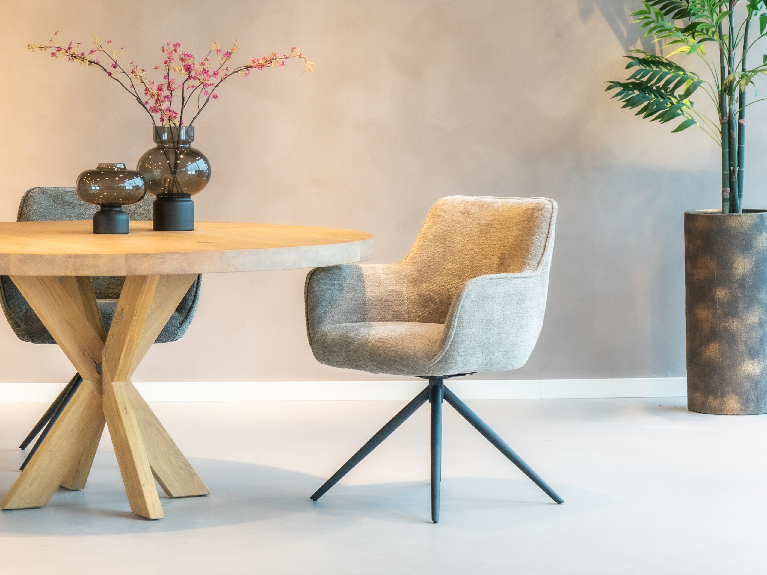 Beige eetkamerstoel met een elegant ontwerp en comfortabele zitting.